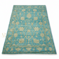 Blue patterned rug with gold accents on a white background