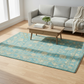 Living room with a gray sofa, wooden coffee table, and blue patterned rug.