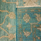 Close-up of a textured blue and beige rug with floral patterns