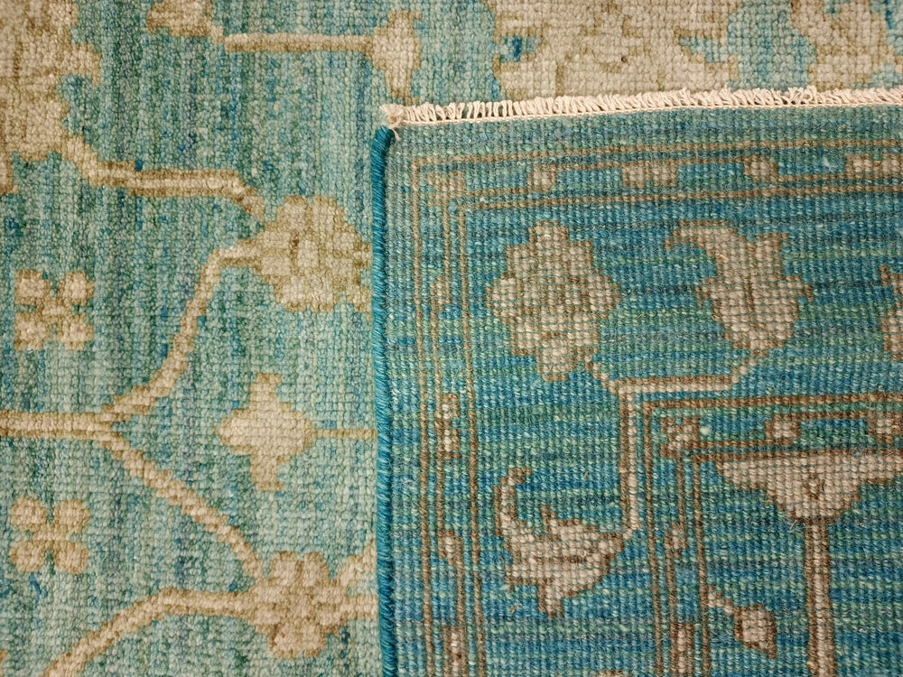 Close-up of a textured blue and beige rug with floral patterns