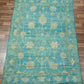 Blue floral patterned rug on a wooden floor