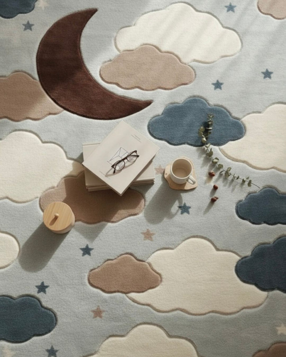 Children's play area with toys on a rug featuring clouds and a moon.