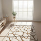 White rug with brown abstract pattern on a wooden floor in a bright room with large windows.