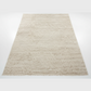 Beige textured rug with a geometric pattern on a white background