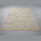 Beige geometric patterned rug on a plain gray background