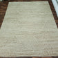 Beige woven rug on a wooden floor