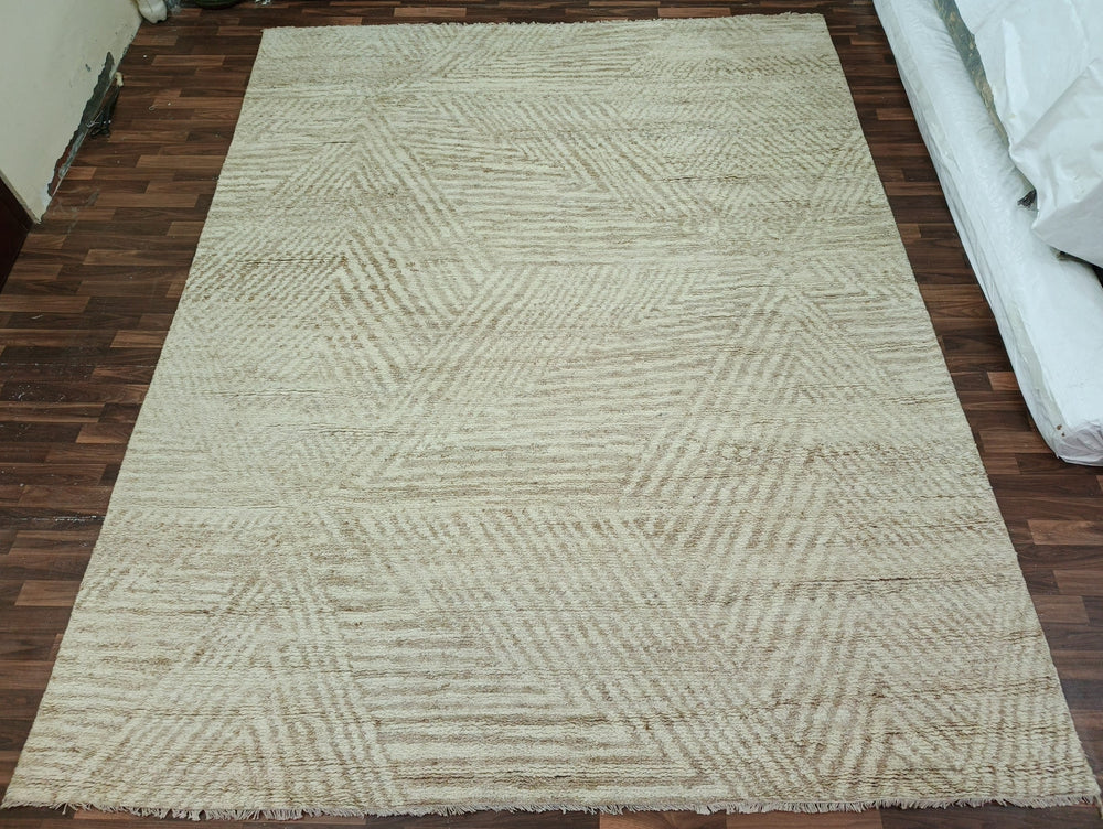 Beige woven rug on a wooden floor
