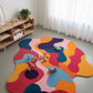 Colorful abstract rug in a room with toys and a shelf.