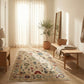 Living room with a patterned rug, wooden bench, and potted plant.