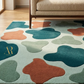 Colorful abstract rug with a pattern of multicolored shapes on a wooden floor.