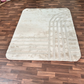 Beige patterned rug on a wooden floor