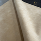Close-up of beige fabric with a brand logo in the corner