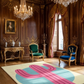 Luxurious room with ornate furniture, chandeliers, and a colorful rug.