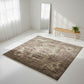 Beige patterned rug on a white floor with a wooden bench and mirror in the background.