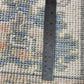 Rug with a ruler for scale showing its thickness