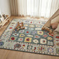 Decorative rug with colorful patterns on a wooden floor, surrounded by toys and a small tent.
