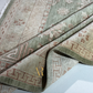 Close-up of a patterned rug with geometric and floral designs.