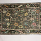 Decorative rug with intricate patterns on a white floor