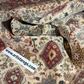 Close-up of patterned rugs with a visible brand label at artistarugs.com