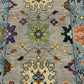 Close-up of a patterned rug with floral designs on a gray background
