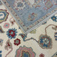 Close-up of patterned rugs with floral designs in blue, red, and beige.