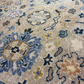 Close-up of a patterned rug with floral and geometric designs.