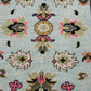Close-up of a patterned fabric with floral designs on a light blue background