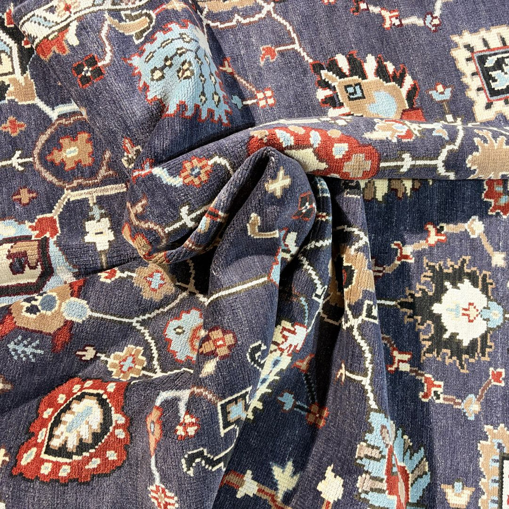 Close-up of patterned fabric with intricate designs on a dark blue background