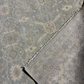 Close-up of a textured gray rug with intricate patterns