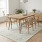 Dining room with wooden table and chairs on a patterned rug