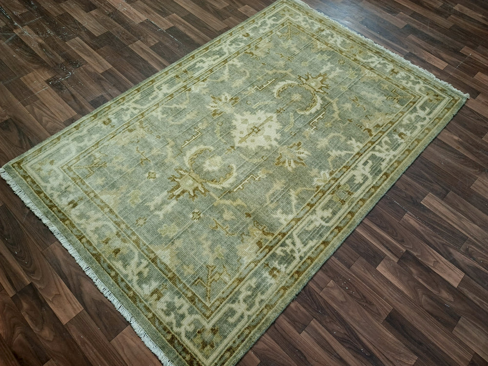 Green patterned rug on a wooden floor