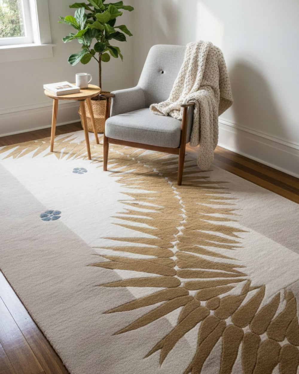 Living room with a rug featuring leaf patterns, a chair, and a small table.
