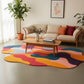 Living room with a colorful abstract rug, beige sofa, and decorative elements.