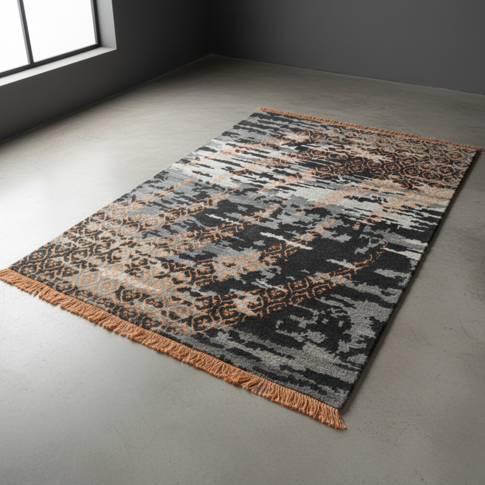 Patterned rug on a gray floor with a dark wall corner.