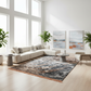 Modern living room with a sectional sofa, coffee table, and abstract art on a white wall.