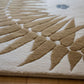 Close-up of a textured rug with geometric pattern on a wooden floor.