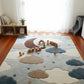 Children's room with a cloud-themed rug and wooden toys.