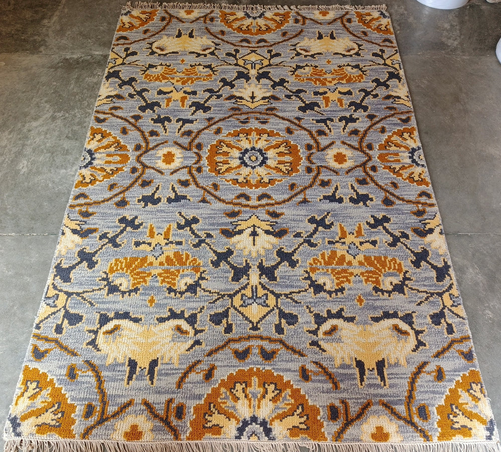 Patterned rug with geometric design on a concrete floor