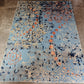 Decorative rug with floral pattern on a concrete floor
