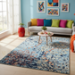 Living room with a colorful rug, sofa, and abstract art on the wall.