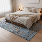 Bedroom with a bed and decorative rug on a wooden floor.