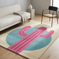 Living room with a pink and blue cactus rug on a wooden floor.