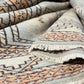 Close-up of patterned rugs with a focus on texture and color.