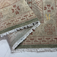 Close-up of patterned rugs with fringes on a light background