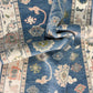Close-up of a blue patterned rug with intricate designs.