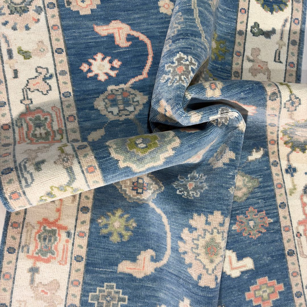 Close-up of a blue patterned rug with intricate designs.