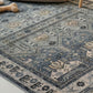 Patterned blue and beige rug on a floor