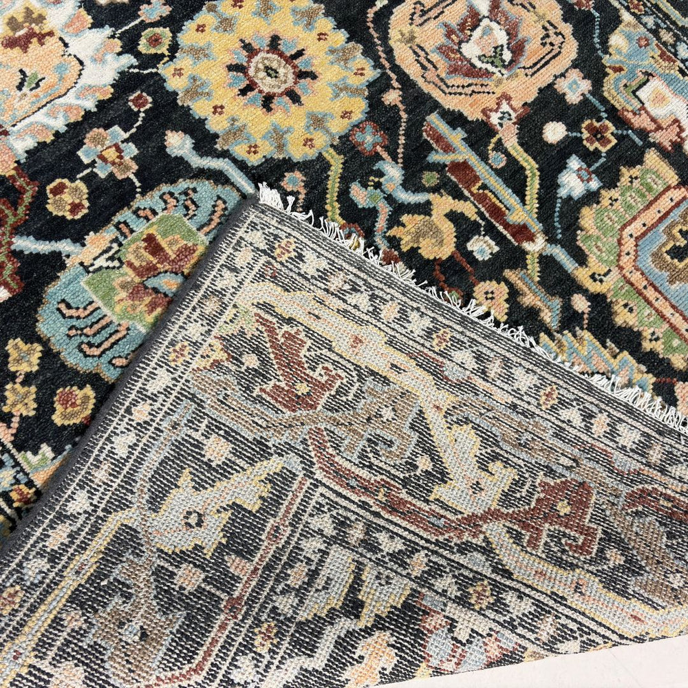 Close-up of patterned rugs with intricate designs on a neutral background