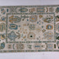 Decorative rug with intricate patterns on a white floor