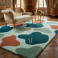 Decorative rug with abstract shapes in a luxurious room with furniture.
